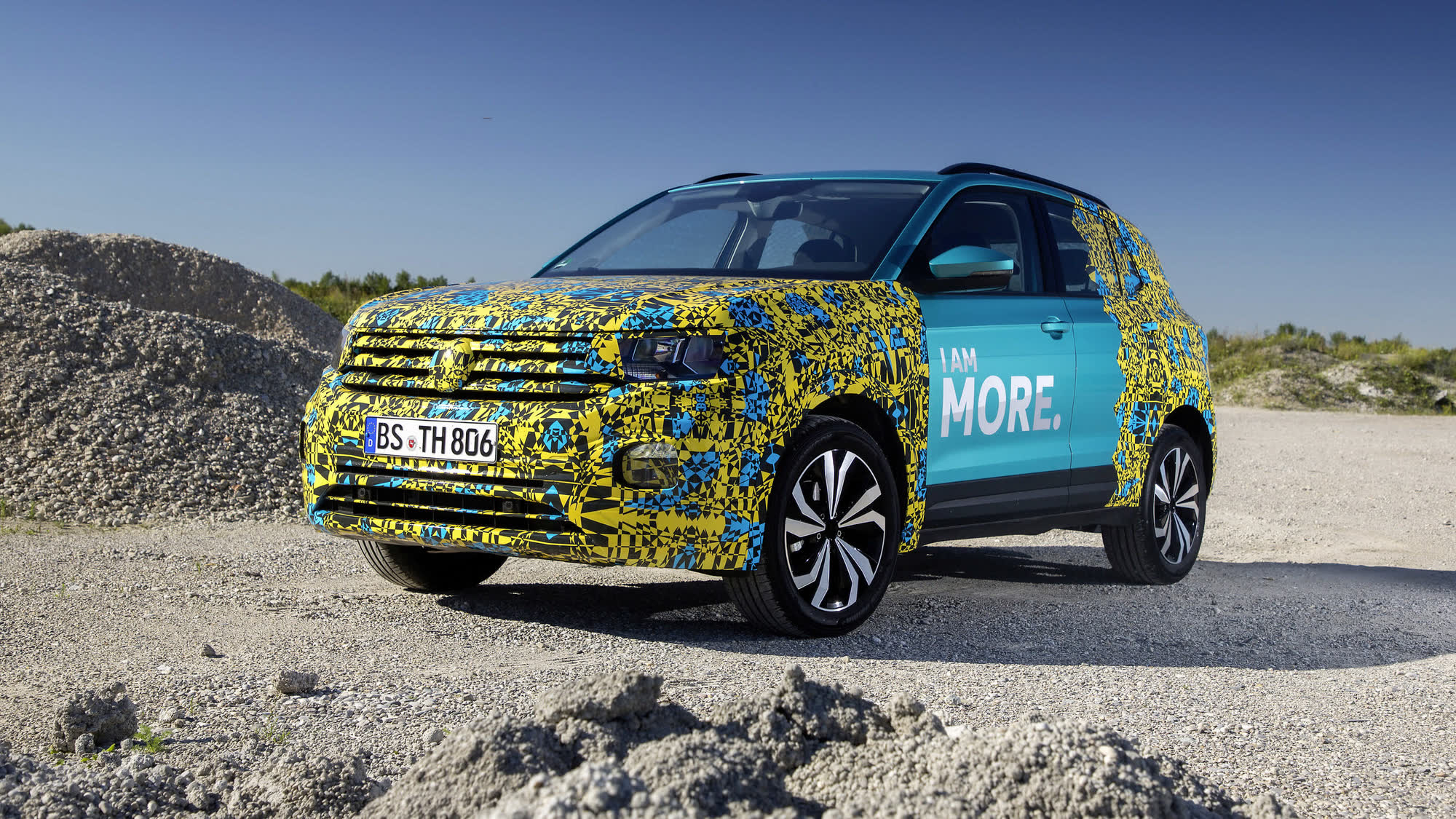 T-Cross pre-launch, yellow camo, front quarter on gravel